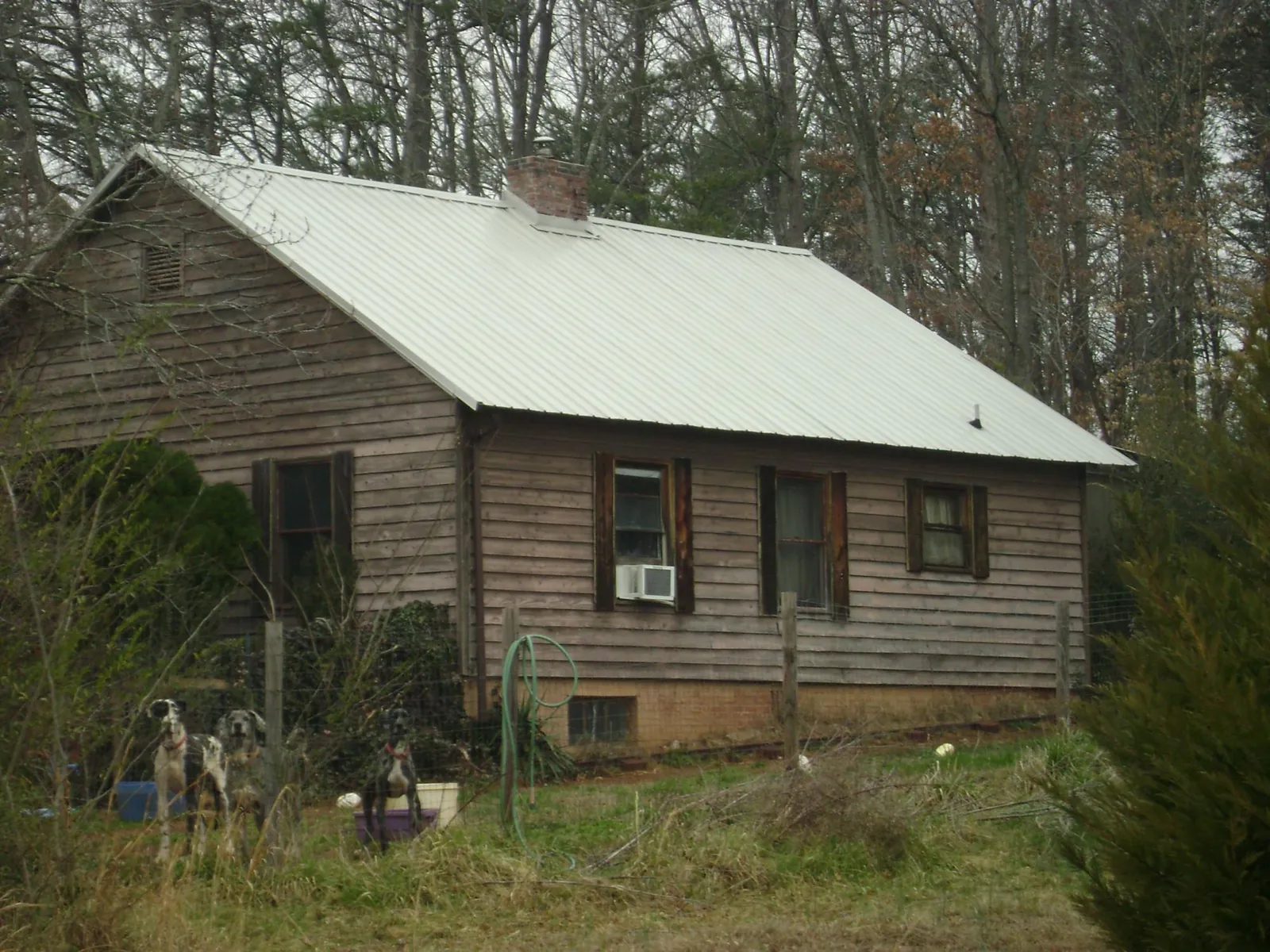 White metal roof on an old wood sided farmhouse, from a Metal Roof Installation job in Newtonsville
